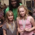 Football legend Linvoy Primus with two medal winners, Betsy Baird from Climping and Stephie Green from North Bersted