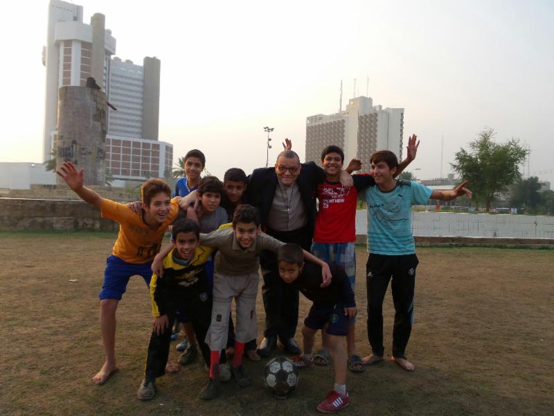 Canon Andrew White with young members of his Baghdad flock