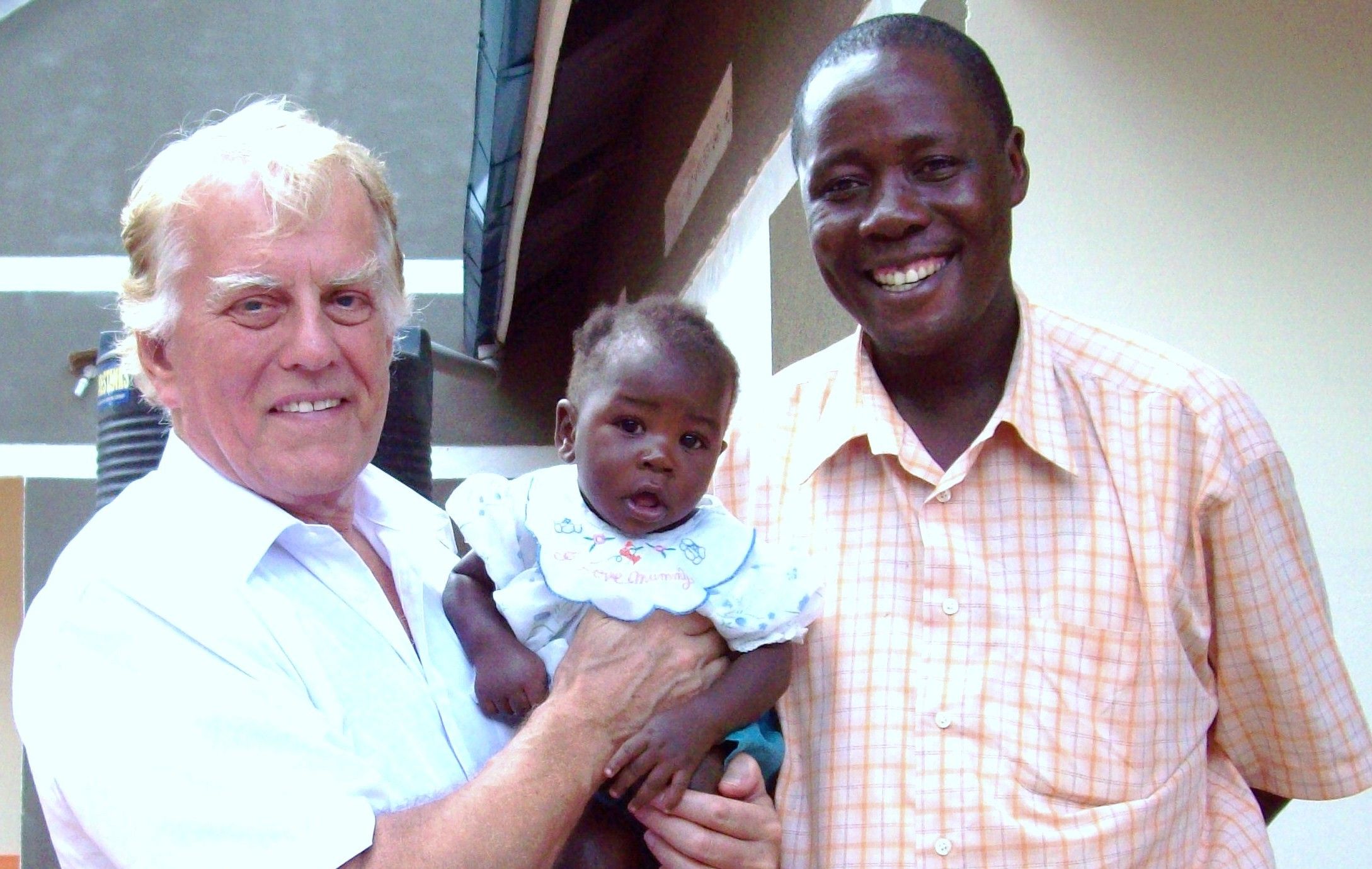 Dr Tony Sargent and former theological student Gabriel Kijjambu from Uganda and Gabriel's child