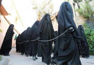 Captured Christian and Yazidi women are chained and forced to wear full Islamic dress Captured Christian and Yazidi women are chained and forced to wear full Islamic dress