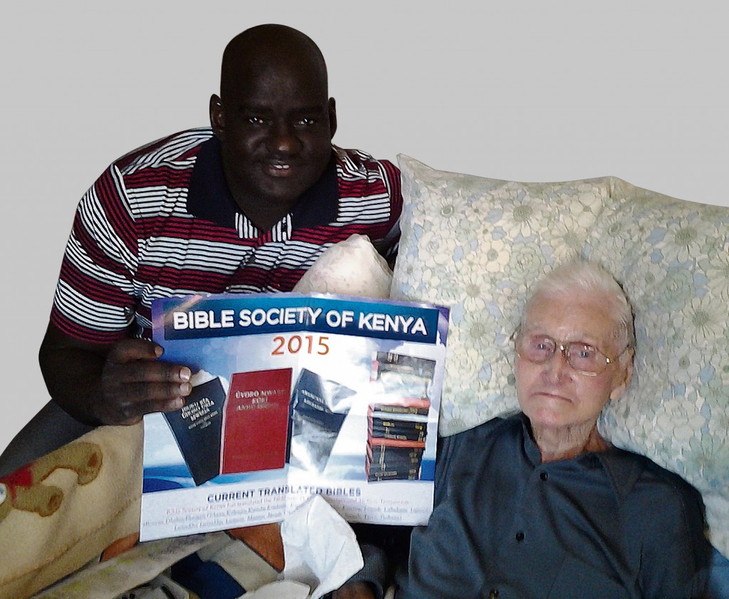 Steve Stevens with Bishop Andrew Ouma and the Kenyan Bible Society poster of Bibles for marginalised people groups. Steve is sponsoring this project.