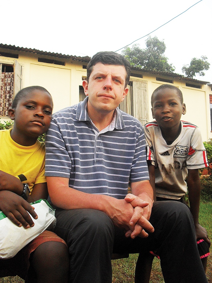Author Daniel Harrison with friends in Uganda, where his ministry helps fund schools and church buildings