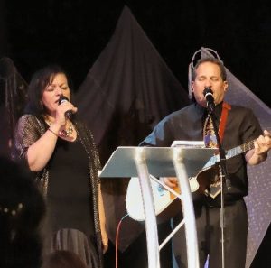 Barry and Batya Segal singing at a Christian and Jewish celebration event in Dorset