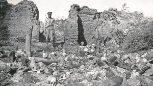 Soldiers surveying the skulls of victims in an Armenian village
