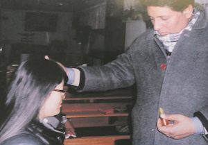 Bishop Yousaf praying for a woman’s healing