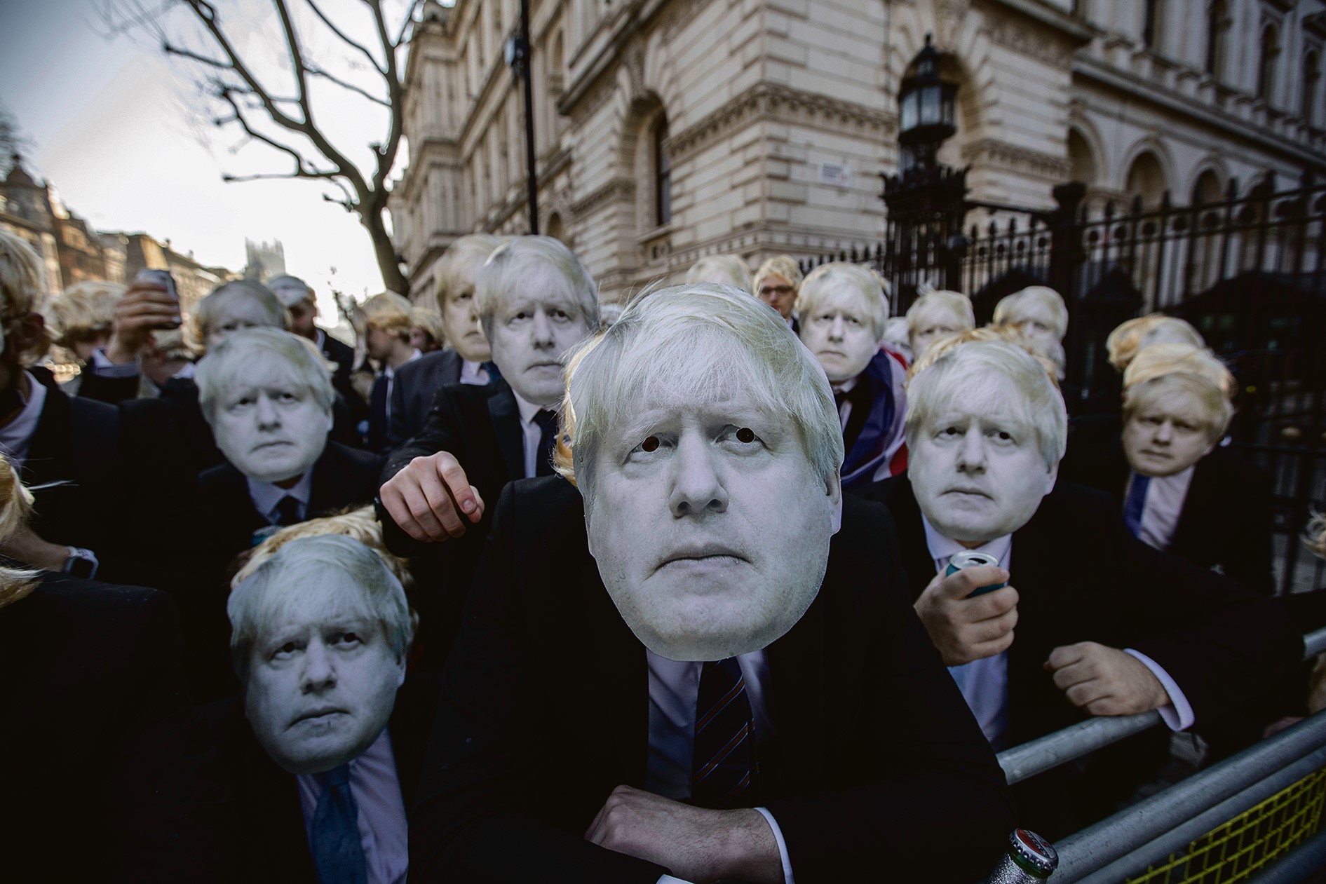Protesters wearing floppy blond wigs and Boris Johnson masks