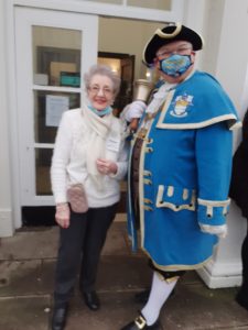 Volunteer Marian Waterer with the town crier, who invited guests to a free meal