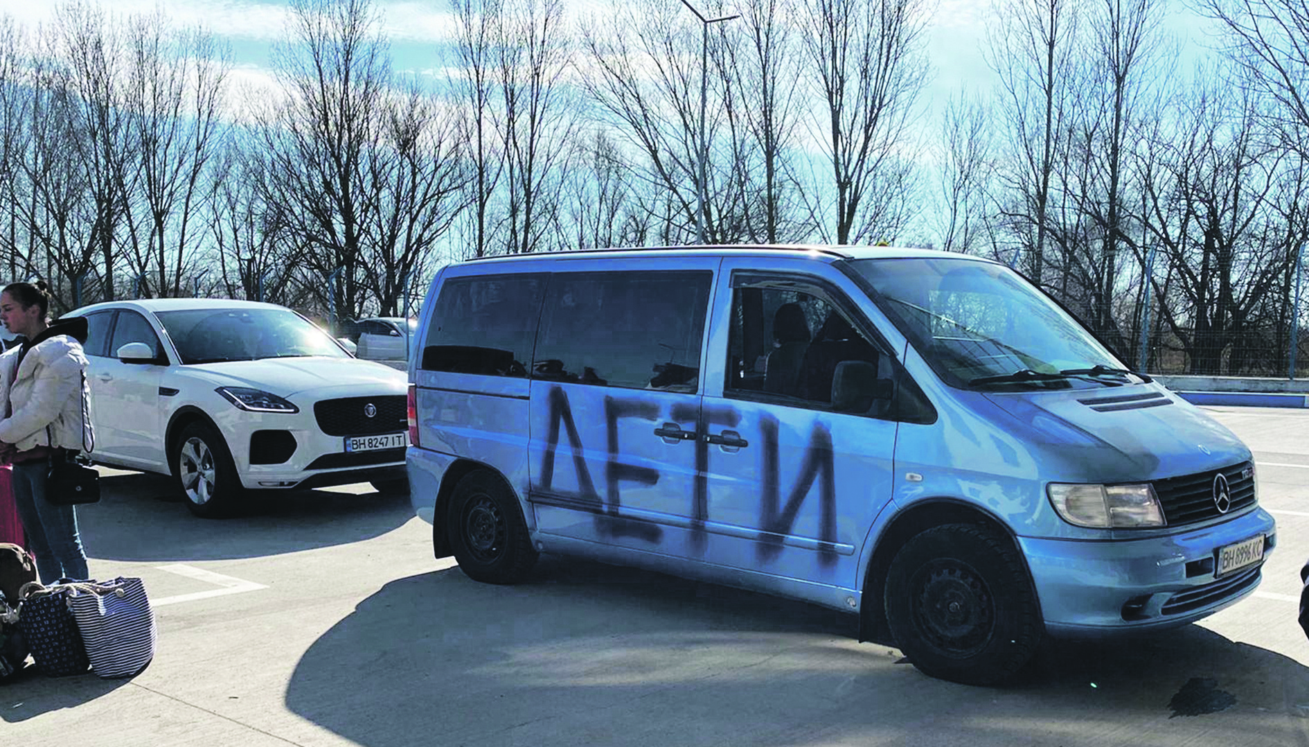 A van with the word 'Children' in Russian spray painted on it